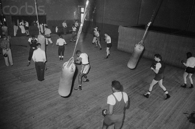 01 Mar 1957 --- Original caption: This is a general view of the upstairs section of Stillman's Gym, where fighters work on the heavy bags to develop their punch, shadowbox to improve timing and footwork, and skip rope to build up the vital leg muscles. --- Image by © Bettmann/CORBIS