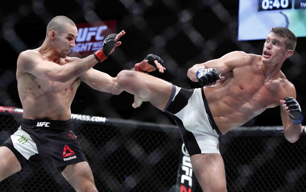 Stephen Thompson, right, kicks to the body of Rory MacDonald during UFC welterweight bout in Ottawa on Saturday June 18, 2016. Thompson won a unanimous decision over MacDonald in a battle of top welterweight contenders at UFC Fight Night 89 Saturday night. THE CANADIAN PRESS/Fred Chartrand