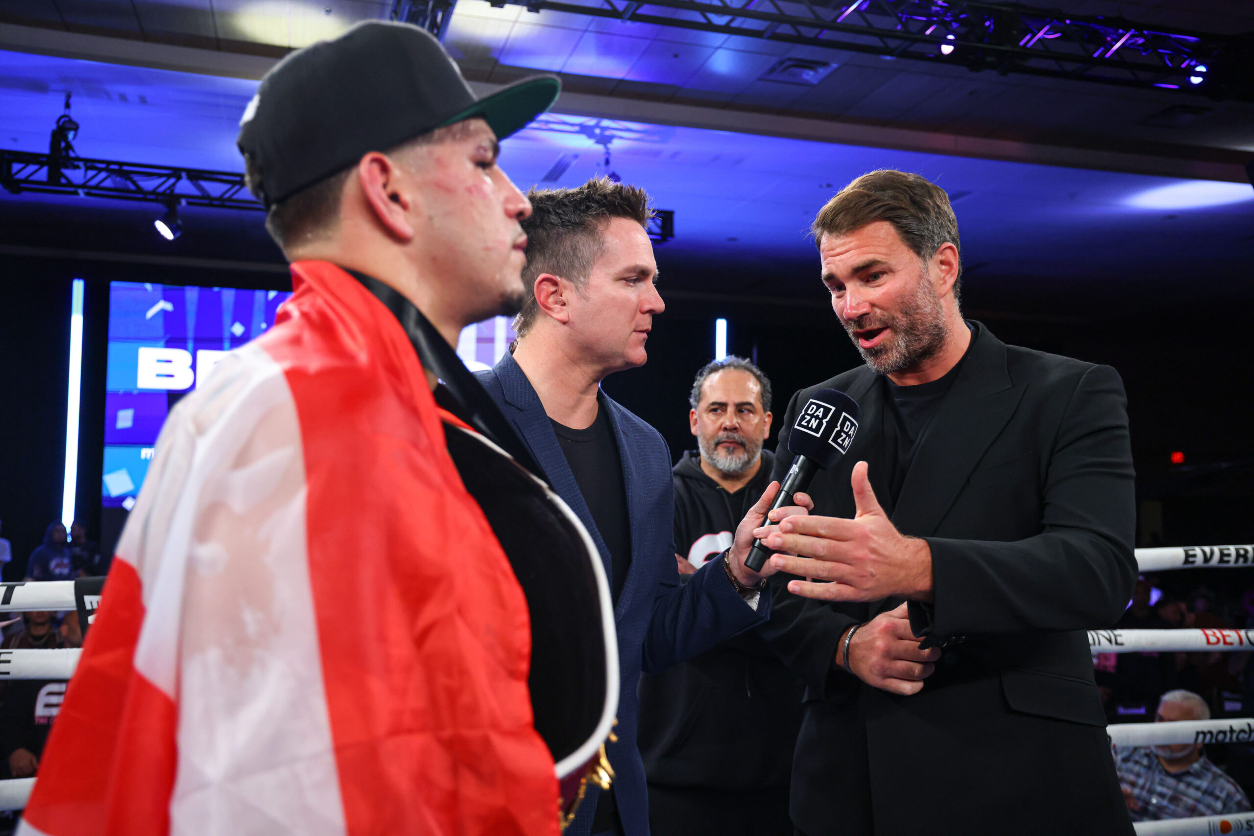February 24, 2024; Orlando, Florida, USA; Edgar Berlanga and Eddie Hearn, Chairman of Matchroom Sport, are interviewed by Chris Mannix after his win over Padraig McCrory after their fight at the Caribe Royale in Orlando, Florida. Mandatory Credit: Ed Mulholland/Matchroom.