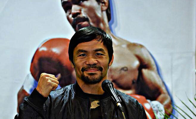 Philippine boxing icon Manny Pacquiao poses for photos during a press conference shortly after arriving at the international airport in Manila on January 24, 2019, days after defeating US boxer Adrien Broner in Las Vegas. (Photo by TED ALJIBE / AFP).