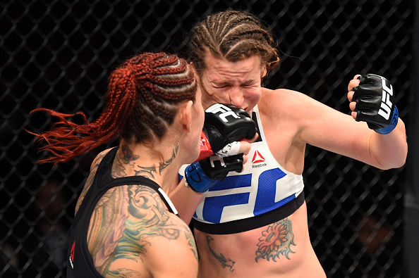 CURITIBA, BRAZIL - MAY 14: (L-R) Cristiane 'Cyborg' Justino of Brazil punches Leslie Smith in their women's catchweight bout during the UFC 198 event at Arena da Baixada stadium on May 14, 2016 in Curitiba, Parana, Brazil. (Photo by Josh Hedges/Zuffa LLC/Zuffa LLC via Getty Images)